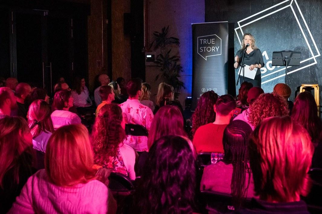 A branded event in the Main Room, with a speaker on stage and a seated audience