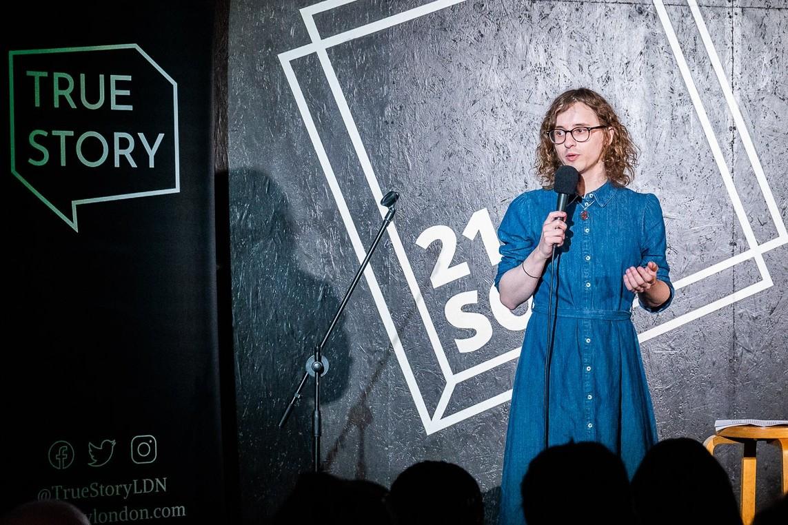 A storyteller on stage at a True Story night at 21Soho